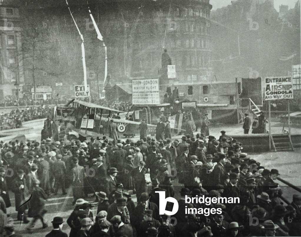 Trafalgar Square: crowd gather around an aircraft, 1918 (b/w photo)