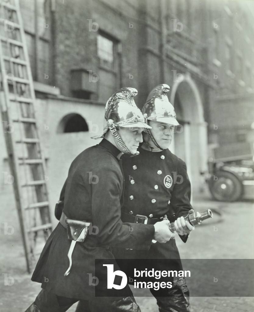 London Fire Brigade: two firemen with a fire hose, 1936 (b/w photo)