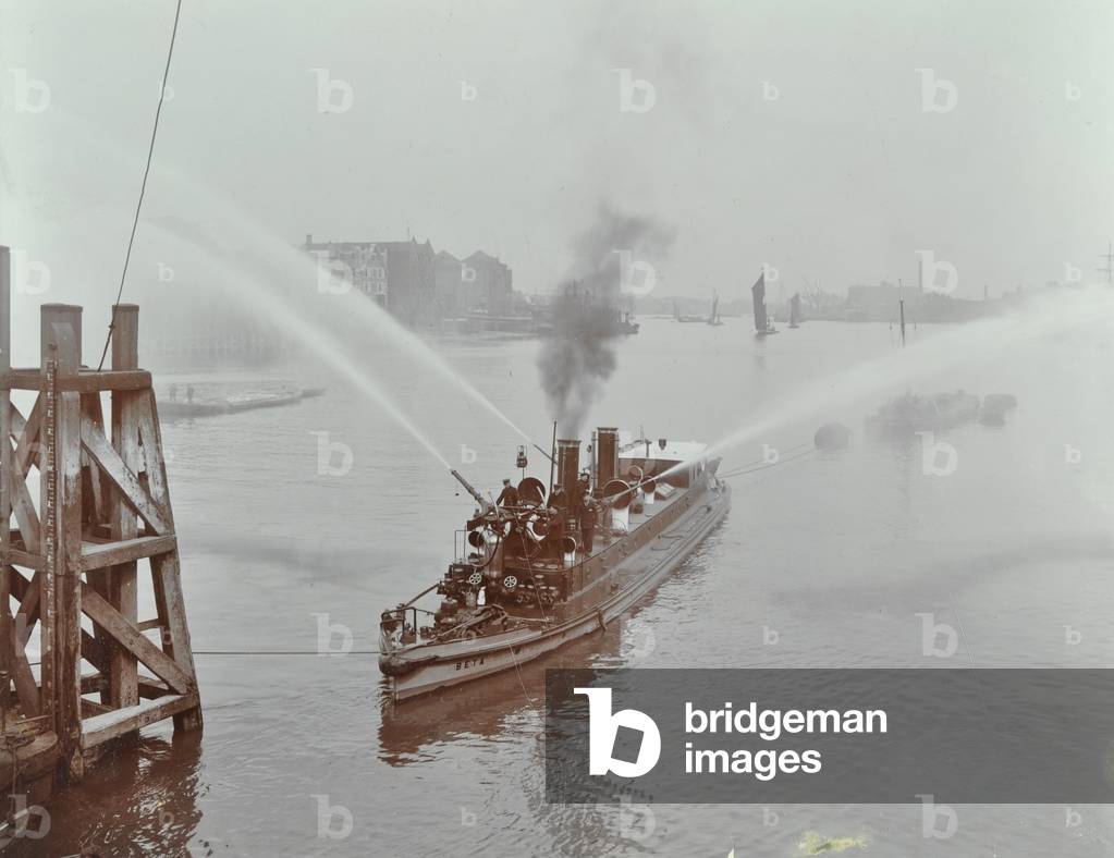 Fire-float 'Beta III', pumping, 1910 (b/w photo)