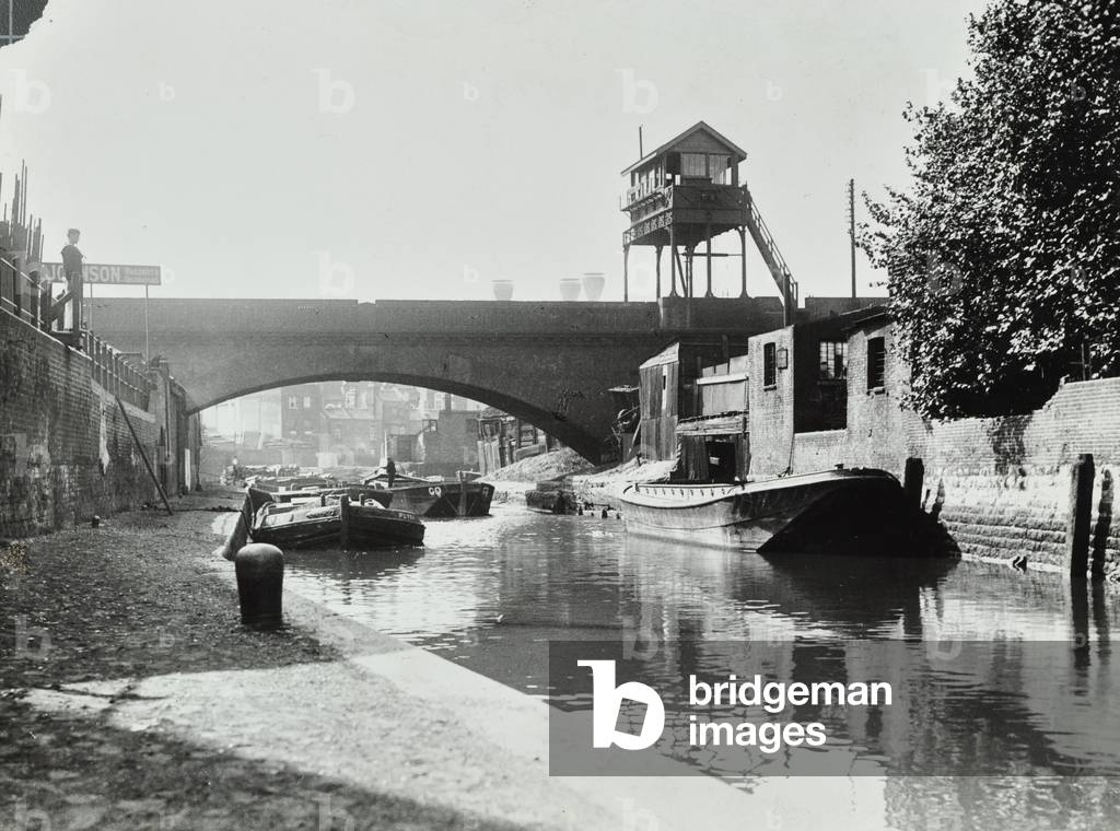 Limehouse Cut. Barges on the water, under a bridge crossing the waterway, 1925 (b/w photo)