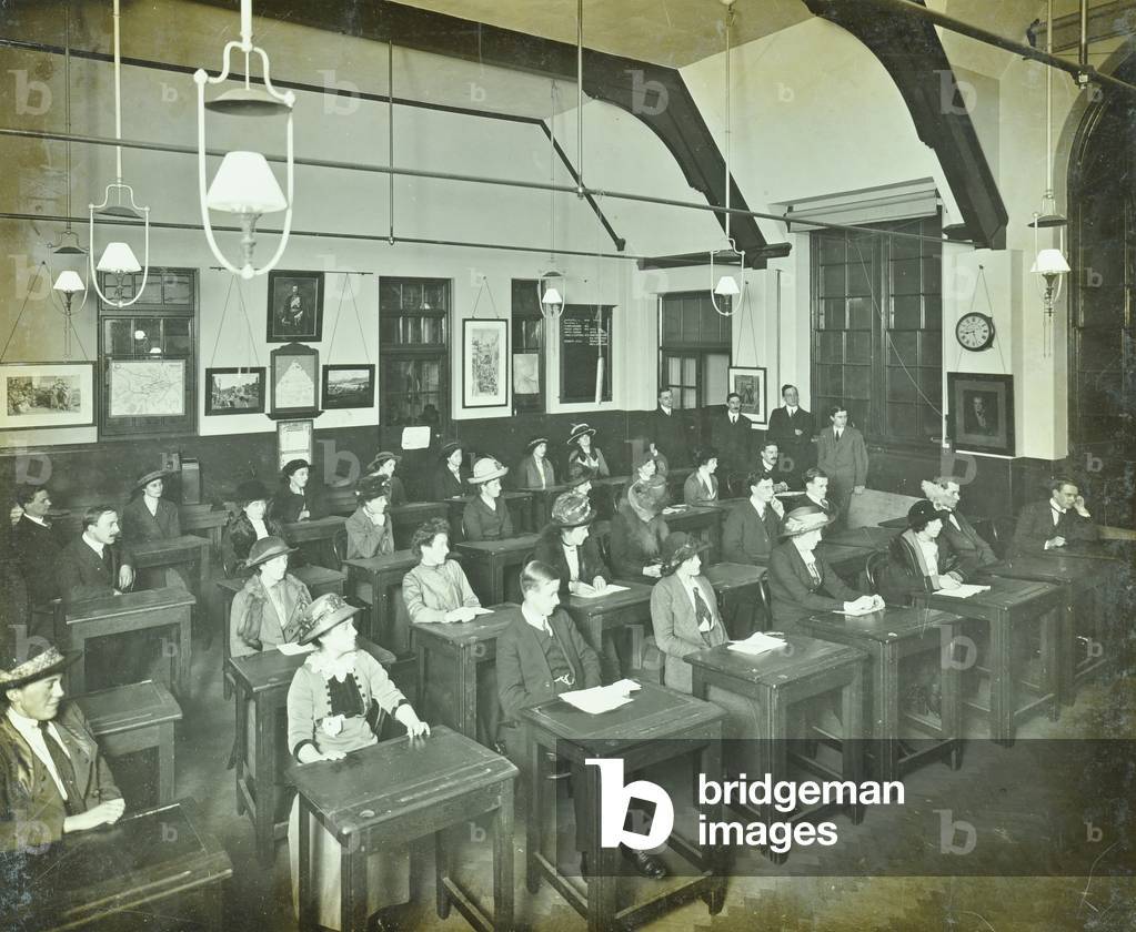 Classroom of William Street School, Hammersmith with men and women at their desks, London, 1913 (b/w photo)