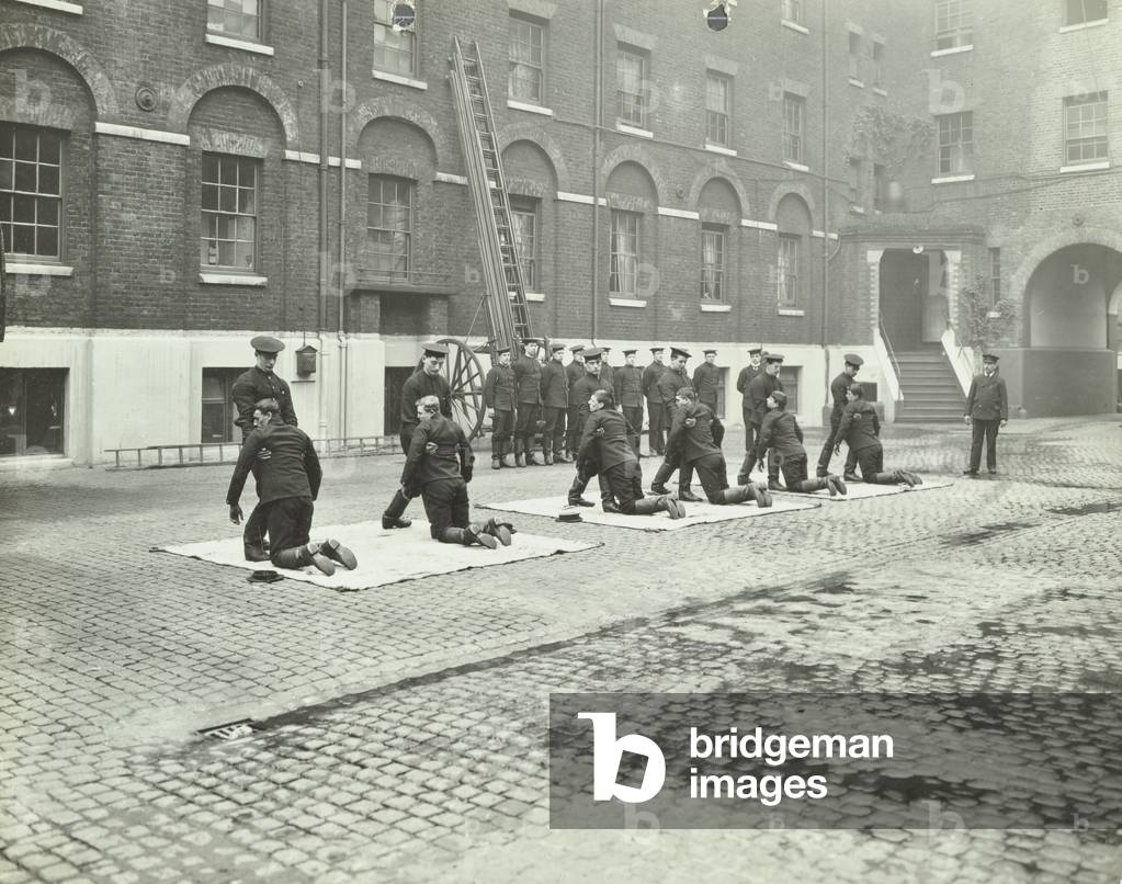 London Fire Brigade Headquarters: drill in lifting unconscious casualties, 1910 (b/w photo)