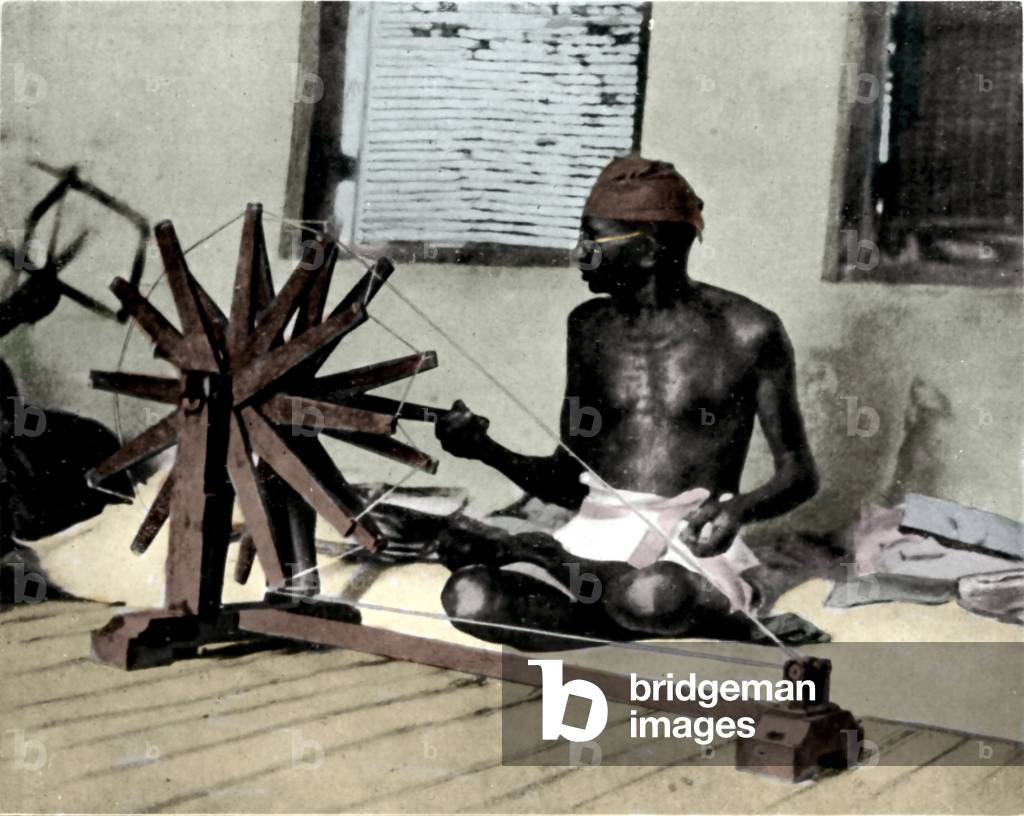 Portrait of political leader Mohandas Karamchand Gandhi (1869-1948) spinning to boycott British products in protest against the British authorities. Photography