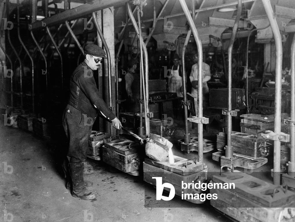 Worker Pouring Castings at Automobile Manufacturer, Detroit, Michigan, USA, c.1920 (b/w photo)
