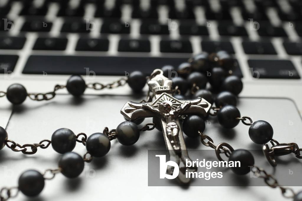 Catholic rosary beads on a laptop keyboard (photo)