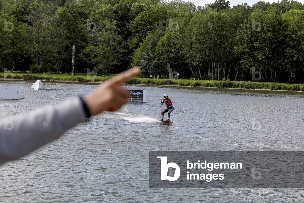 Young man wakeboarding in Damville, France.