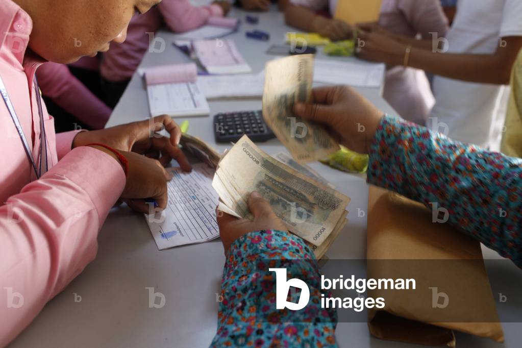 Microcredit reimbursement in the Pochentong branch office of Chamroeun microfinance Pochentong Cambodge
