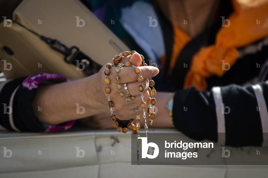 Woman Praying the Holy Rosary during Pope Francis's weekly general audience in St. Peter's Square at the Vatican.