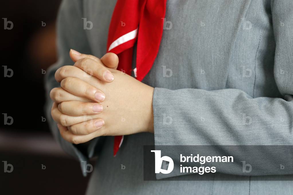 Catholic nun prayer in a church, Close-up on hands, Hoi An Cathedral, Vietnam, 2019 (photo)