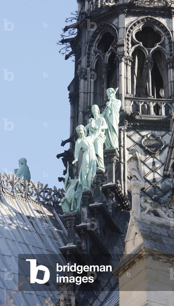Statues of 3 apostles at the foot of Notre-Dame-De-Paris cathedral spire, Paris, France