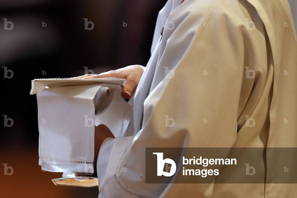 Catholic church during covid-19 epidemic. Sunday mass.  Altar boy  at eucharistic celebration.  Sallanches.  France.