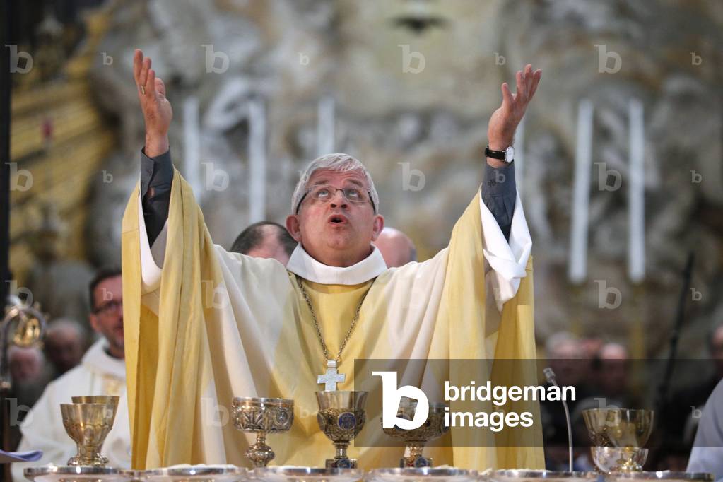 Amiens cathedral Eucharistic celebration Priest raising his arms, Amiens, France