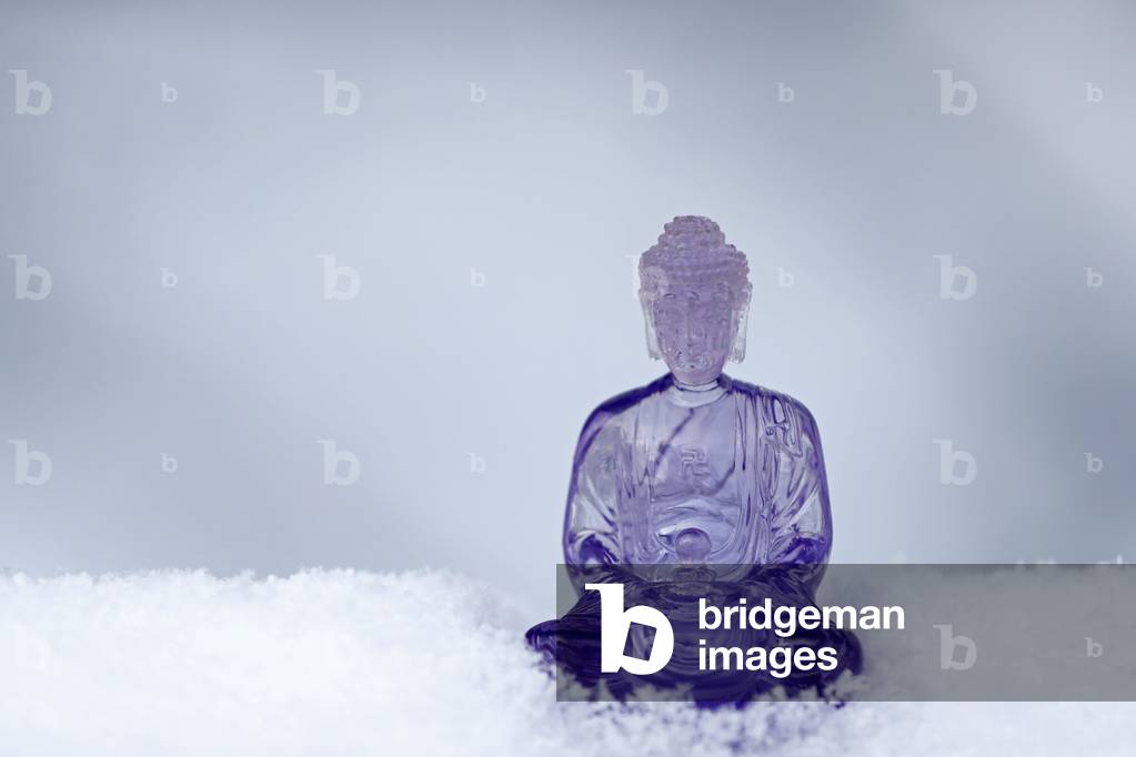 Purple plastic buddha statue in the snow, France, 2019 (photo)