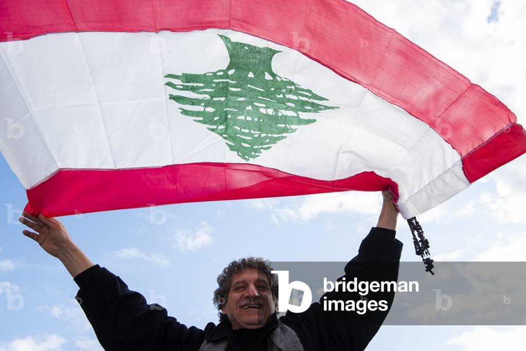 Lebanese Faithful holding a flag during Pope Francis's weekly general audience in St. Peter's Square at the Vatican.