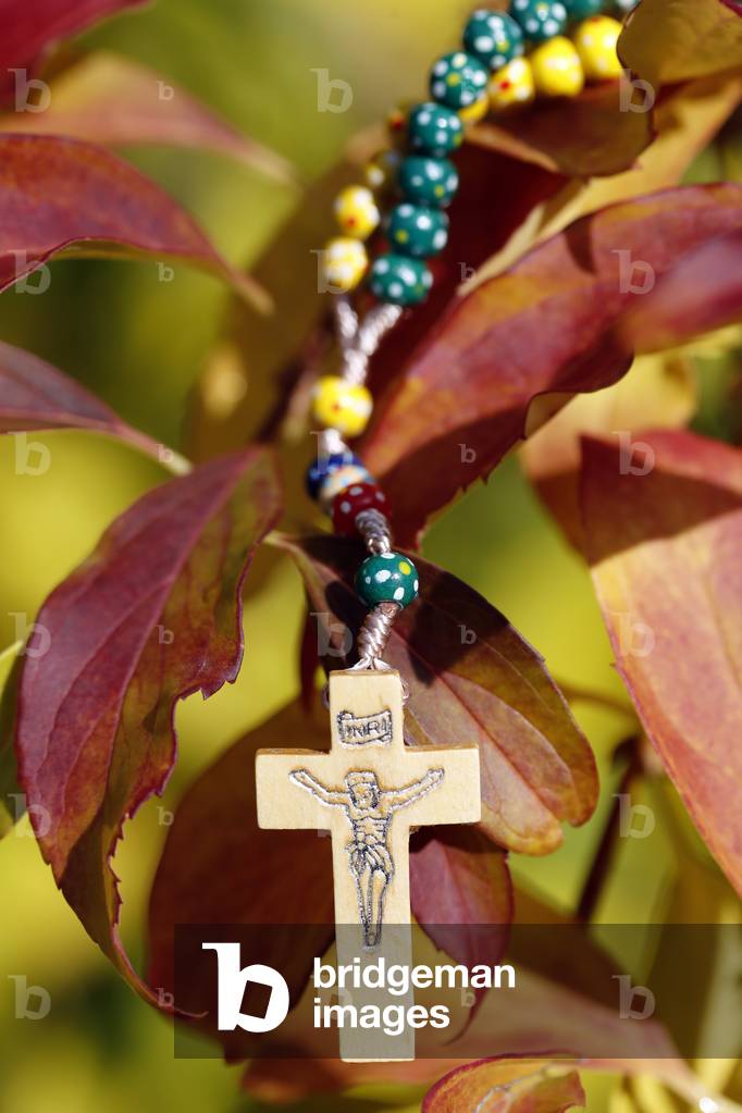 Catholic church. Wooden rosary with autum leaves.  France.