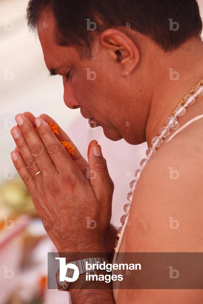 Puja in a Hindu temple : Prayer with flowers, Haridwar, India