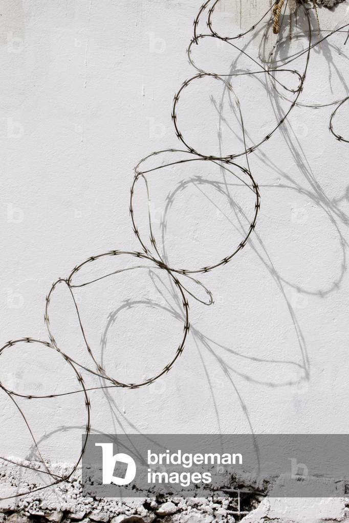 wall and barbed wire, Port-au-Prince, Haiti