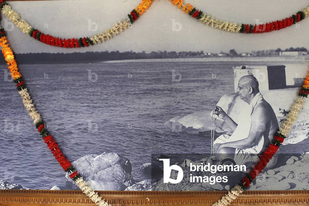 Garlanded picture of the master in Swami Sivananda's ashram, Rishikesh, India