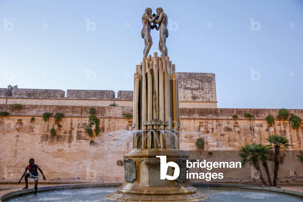 Boy wading in a Maglie fountain, italy (photo)