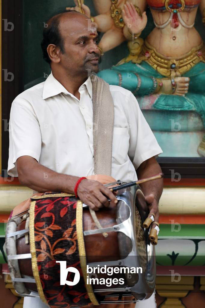 Sri Mahamariamman Hindu Temple, Musician playing a Thavil, traditional Indian drum, Kuala Lumpur, Malaysia (photo)