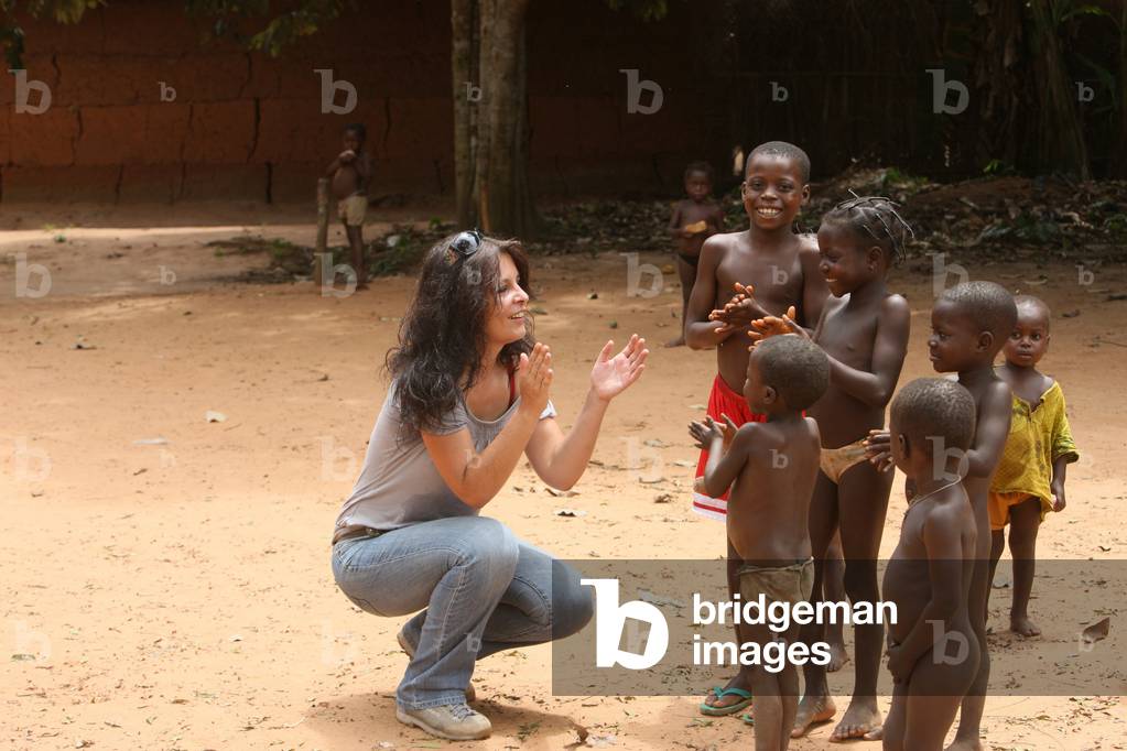 French woman playing wih African children, Tori, Benin