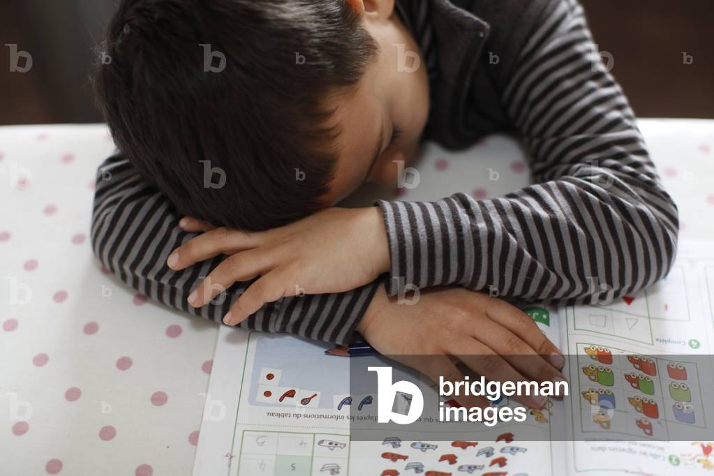 Image of Photography depicting 6-year-old boy falling asleep on his homework Montrouge France