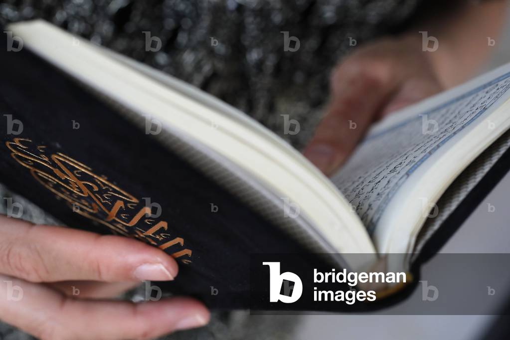 Woman reading the Noble Quran, Close-up,  (photo)