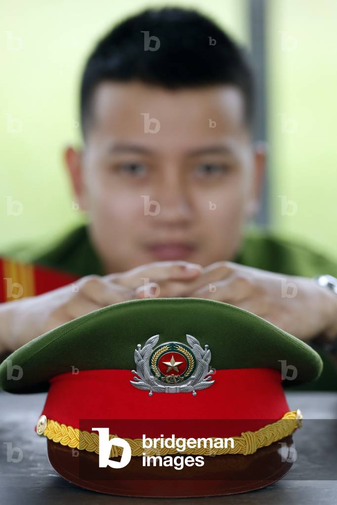Vietnamese soldier and his cap, Portrait, Hue, Vietnam, 2019 (photo)