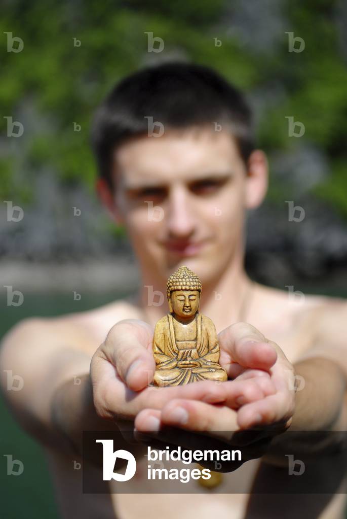 Man with Buddha statue, Halong, Vietnam