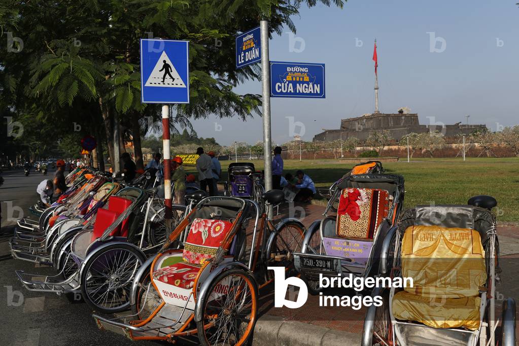 Tradional vietnamese cylos on street waiting for customer in front the imperial city, Hue, Vietnam, 2019 (photo)