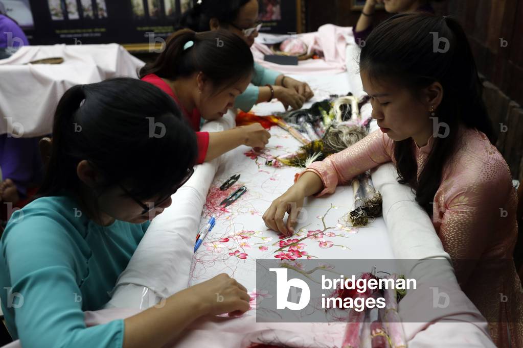 Young female workers doing embroidery, Hue, Vietnam, 2019 (photo)