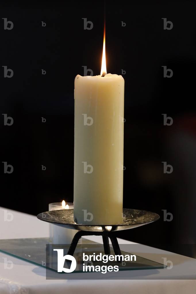 Church candle on altar.  France.