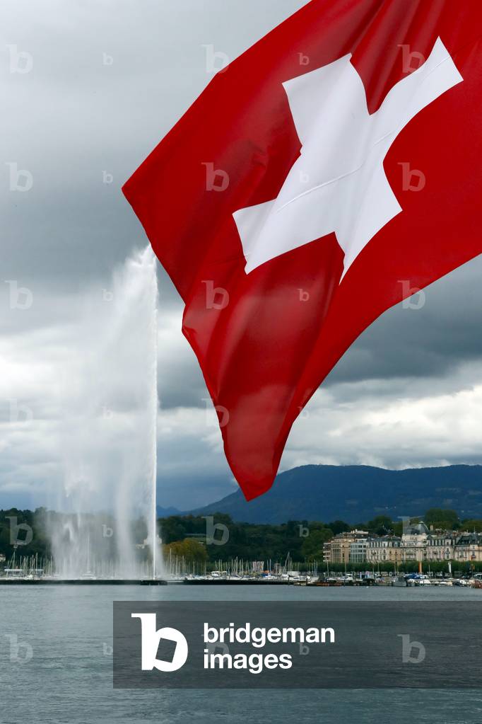 Swiss flag and Jet d'Eau, the world's tallest fountain, on Lake Geneva (Lake Leman).