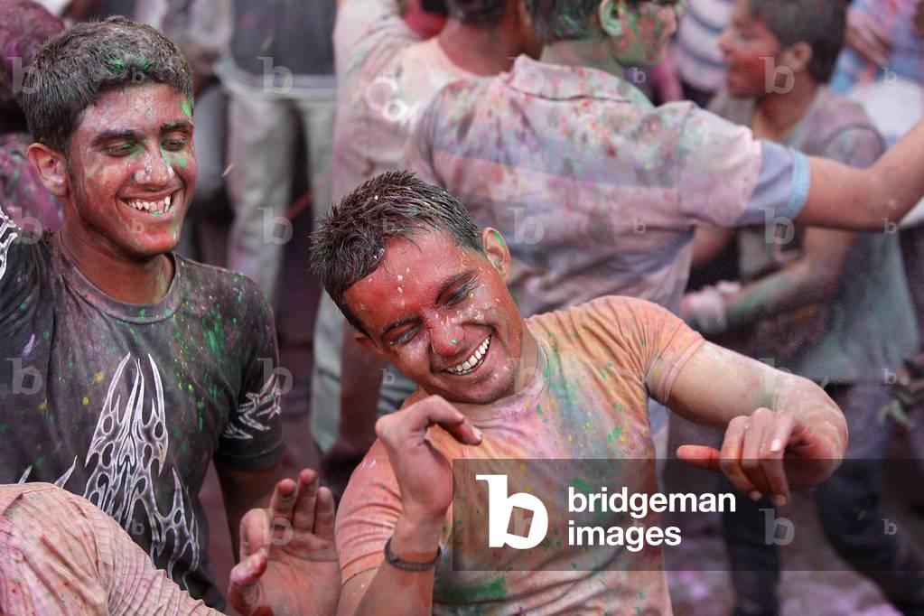 Men celebrating Holi festival Barsana Inde