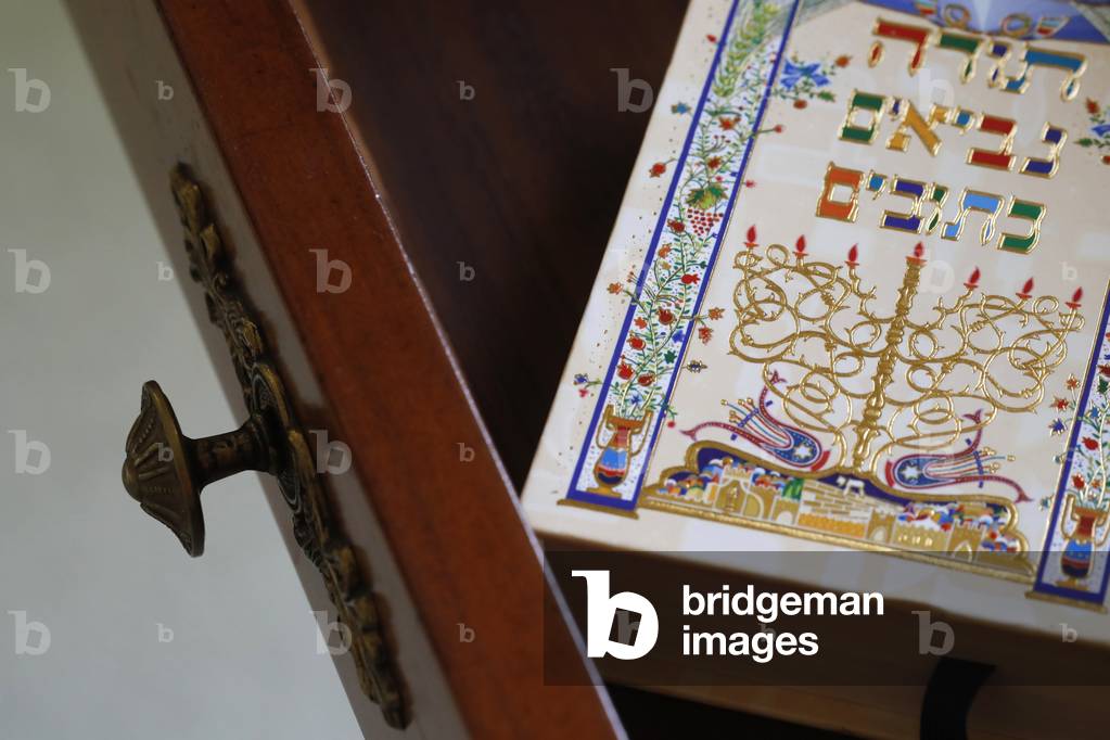 Torah on the bedside table in the interior of bedroom, France, 2019 (photo)