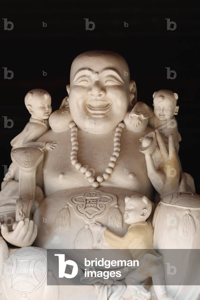 Laughing Buddha surrounded by children, The most common number of children is five, Vietnam, 2019 (photo)