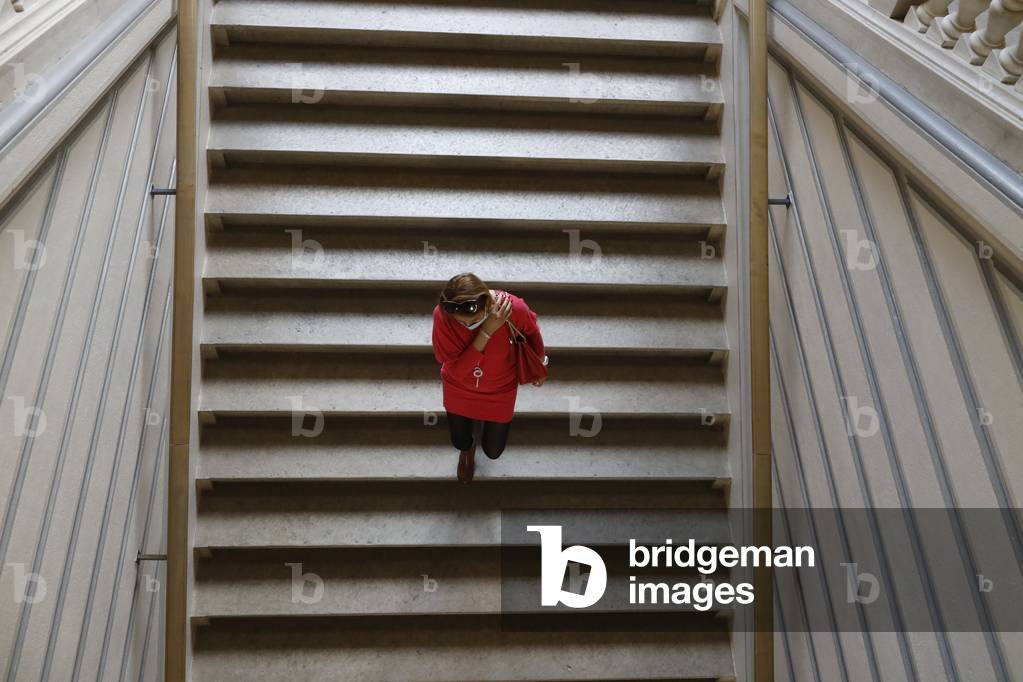 Jenish museum. Woman walking down stairs.