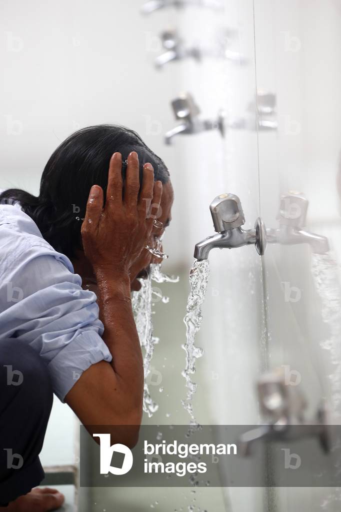 Masjid Al Rahim Mosque, Ritual purity in Islam, Muslim performing Wudu ( ablution ), Ho Chi Minh City, Vietnam (photo)