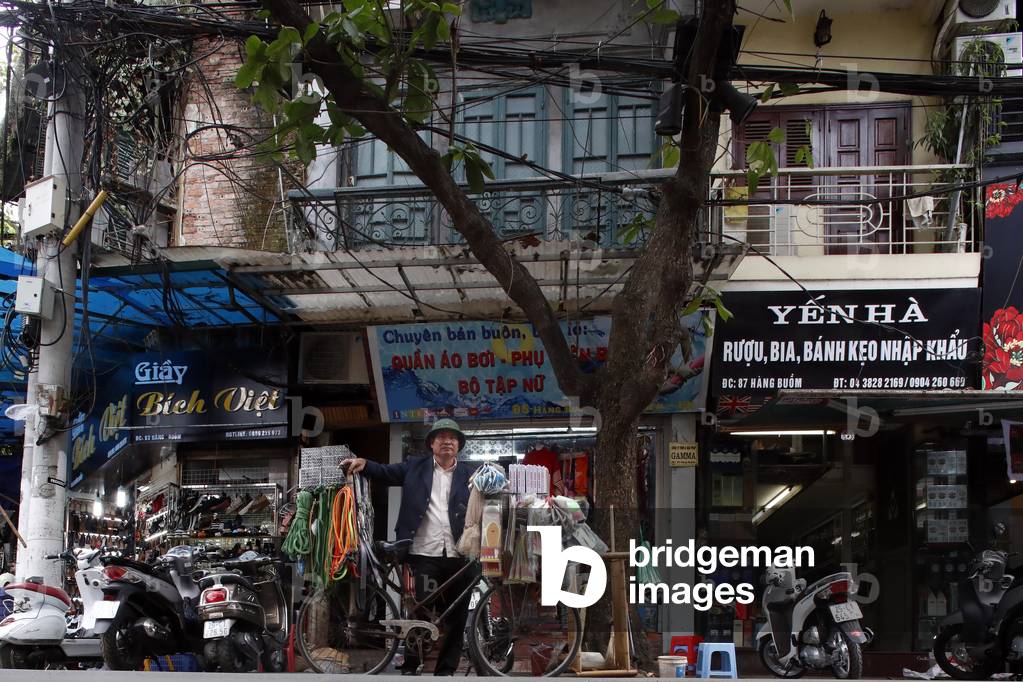 Typical street of the Old Quarter in Hanoi, Chaotic street life traffic, Vietnam (photo)