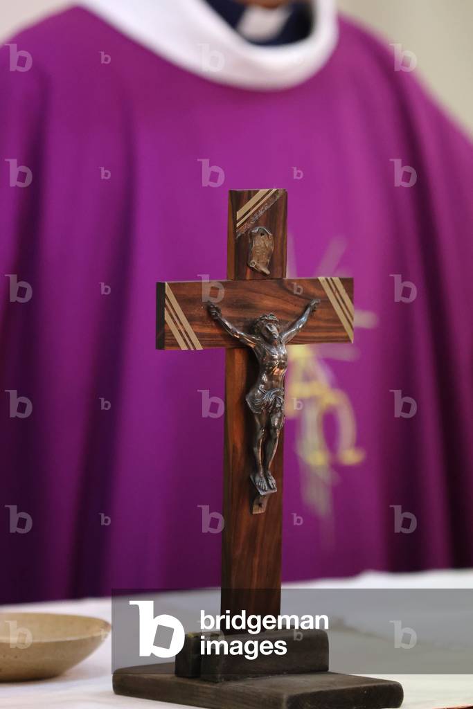 Catholic church during covid-19 epidemic.  Celebration of the mass.  Priest and crucifix.  Saint Joseph church.  France.