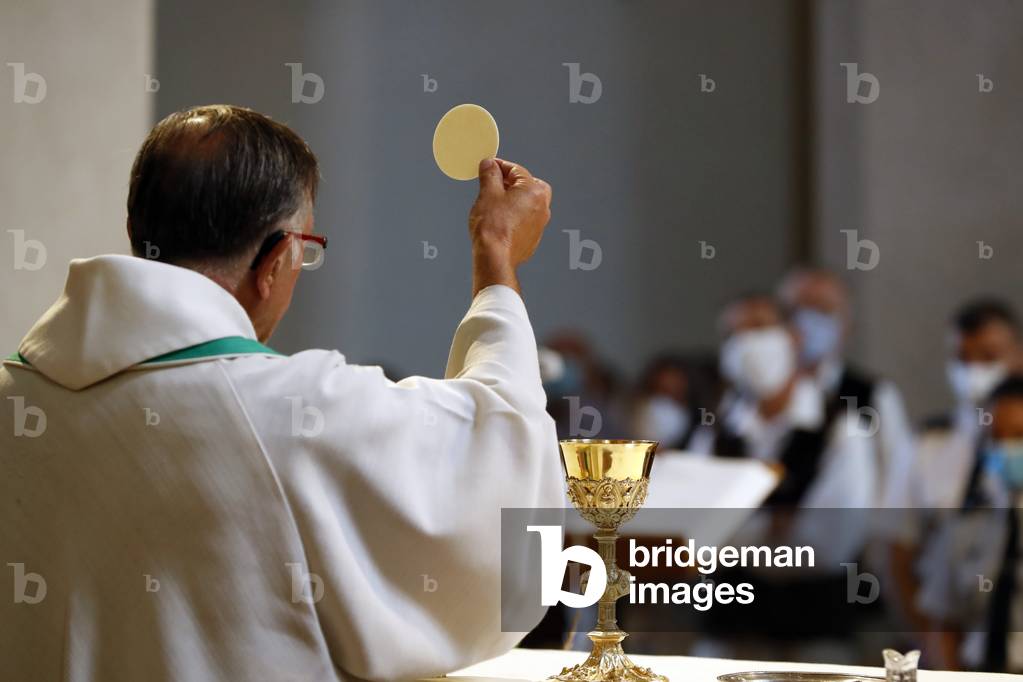 Catholic church during covid-19 epidemic. Sunday mass. Holy Communion.  Saint Gervais. France.