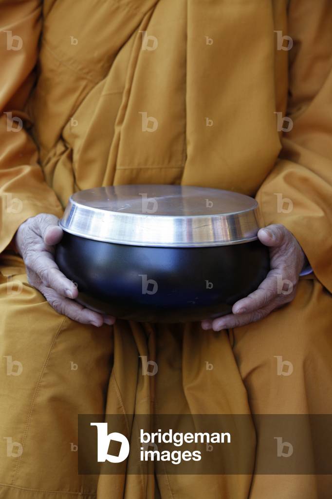 Buddhist nun holding her alm bowl Paris France