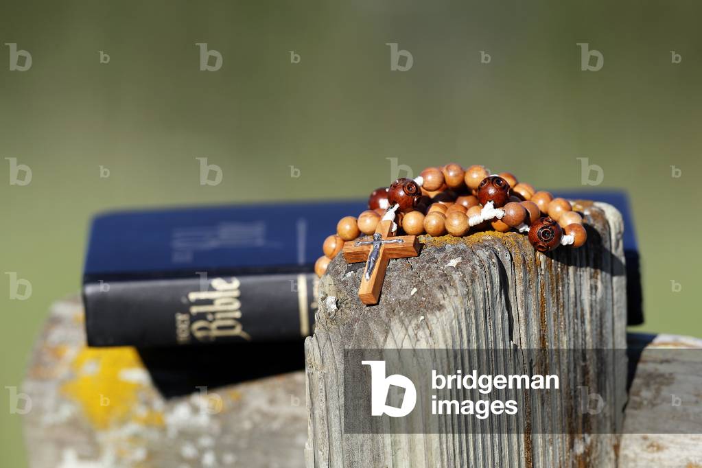 Bible and rosary in nature on a bench.  Combloux. France.