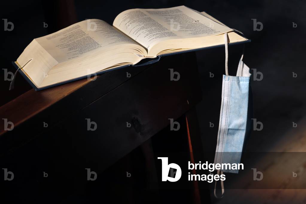Catholic church. Bible, surgical mask. Covid-19 epidemic.  France.