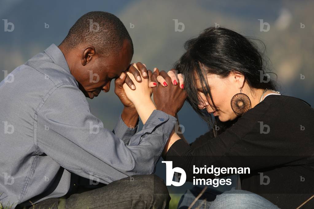 Man and woman praying in the mountain. Saint-Gervais France