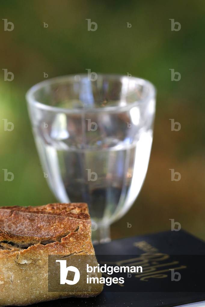 Bread, glass of water, and holy Bible during lent.