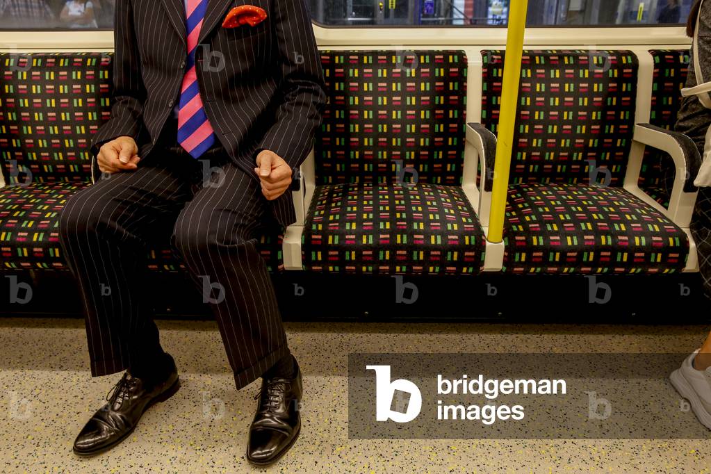 Man straveling on the London underground, UK, 2018 (photo)