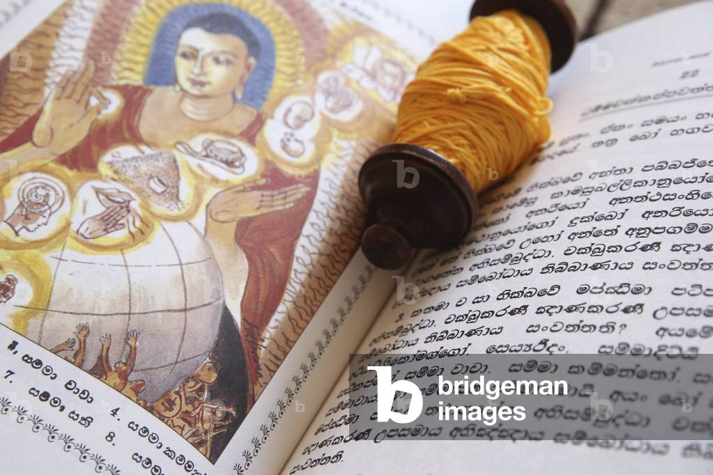Geneva, Geneva, Switzerland, le 5/7/2015 - Buddhist sacred texts and a roll of Sai-Sin (sacred thread). Life of Siddhartha Gautama : the Supreme Buddha.