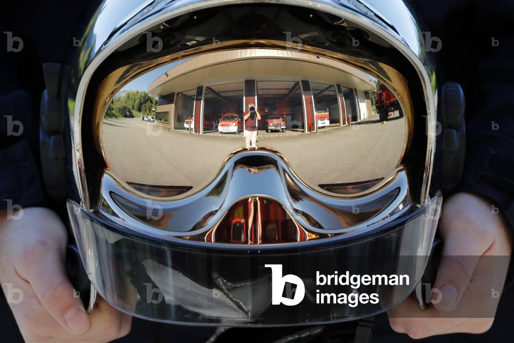 Fire department.  Firefighter and helmet. French Sapeurs Pompiers. France.