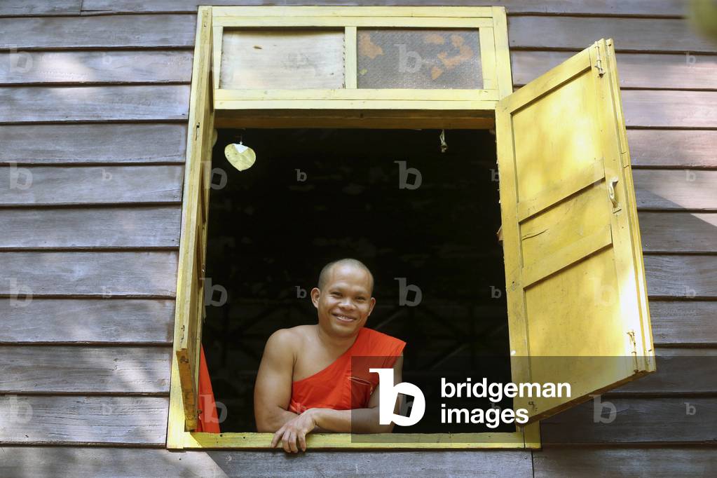 20151030, Vientiane, Laos : Wat Si Muang ( Simuong) buddhist temple. Smiling buddhist monk in the window of his house